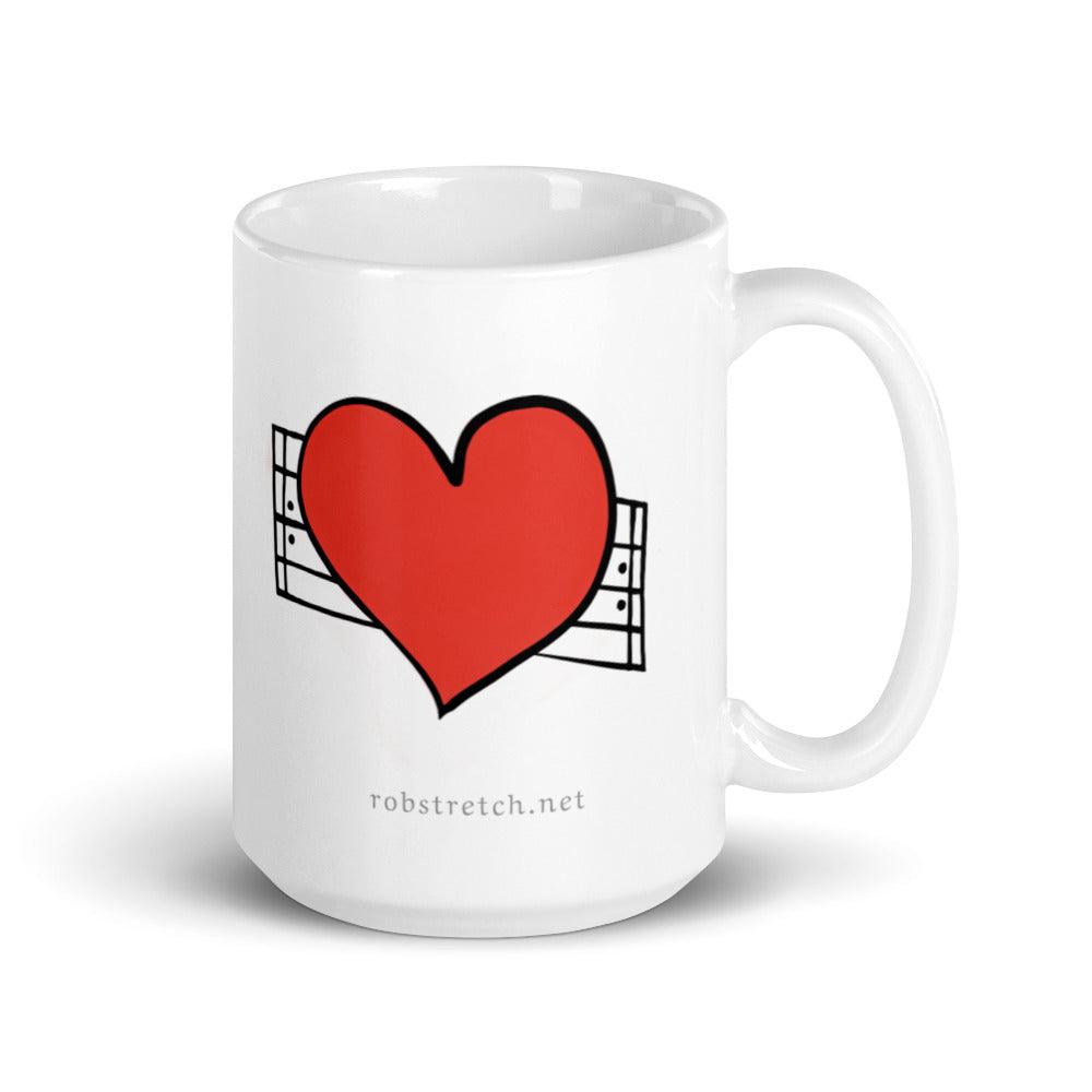 Love Repeat mug featuring a red heart design with musical notes on a white coffee cup